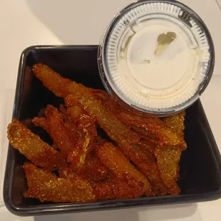 a tray of fries and a dipping sauce