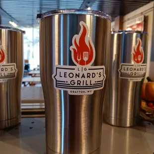 stainless steel cups on a shelf