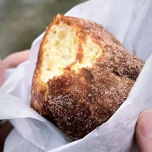 a hand holding a pastry