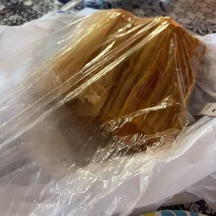 Tamales served steaming from a plastic bag