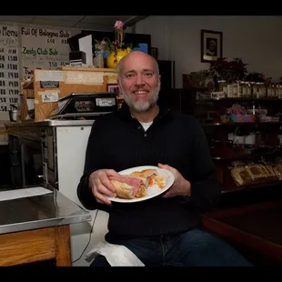 A very happy Leone'Market customer enjoying an Italian Submarine