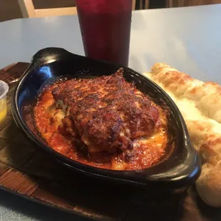 a plate of lasagna and bread