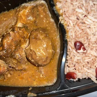Brown stew chicken and rice and peas
