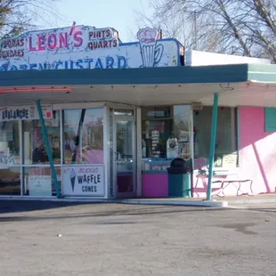 SIGN NEEDS RETOUCHING BUT STANDS ON BUSY STREET