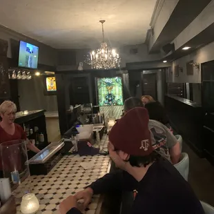 a group of people sitting at a bar