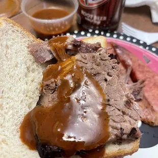 a hand holding a sandwich