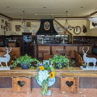 a table with flowers and deer statues
