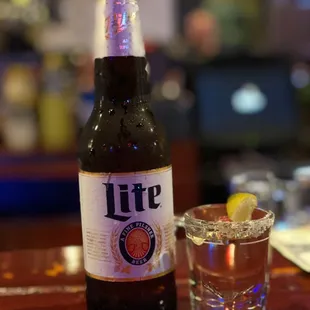 a bottle of beer and a shot glass