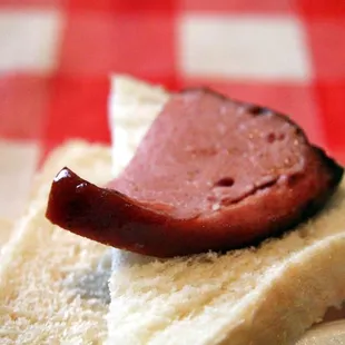 a hot dog on a piece of bread