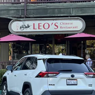 a white suv parked in front of the restaurant