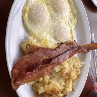 3 eggs over easy, bacon, Hashbrowns and toast on the side