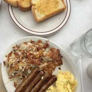 a breakfast of eggs, sausages, toast, and toast