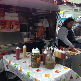 a woman preparing hot dogs