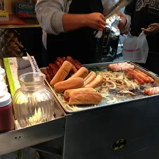 a hot dog vendor selling hot dogs