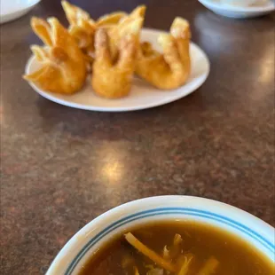a bowl of soup and some appetizers