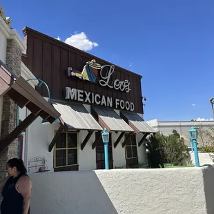 a woman walking past a restaurant