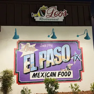 A colorful mural painted on the side of Leo&apos;s Mexican Restaurant :) ! It looks like an enlarged postcard :D !