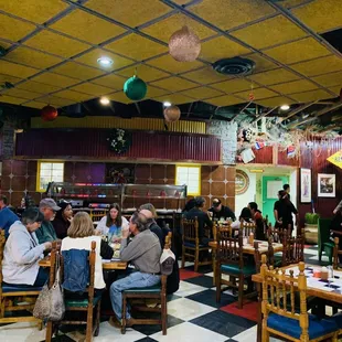 Restaurant guests enjoying the festive and relaxing ambience of Leo&apos;s decorated beautifully for the holiday season :) !
