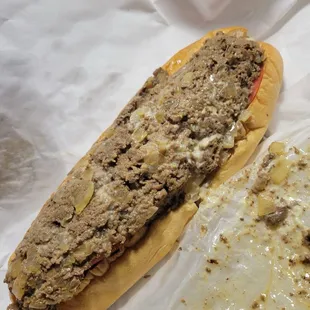Cheesesteak with onions, lettuce and tomato.