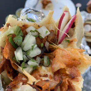 a hand holding a taco