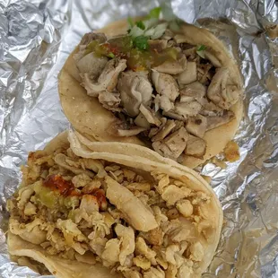 two tacoss wrapped in tin foil