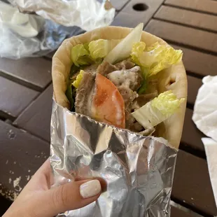 a hand holding a burrito