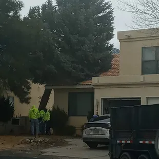 a man and a woman standing in front of a house