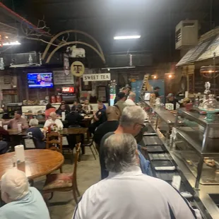 people sitting at tables in a restaurant