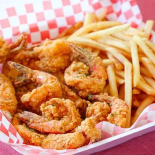 a basket of fried shrimp and fries