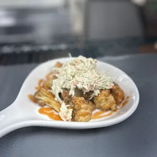 Flash fried cauliflower with honey hot sauce and house made tangy coleslaw