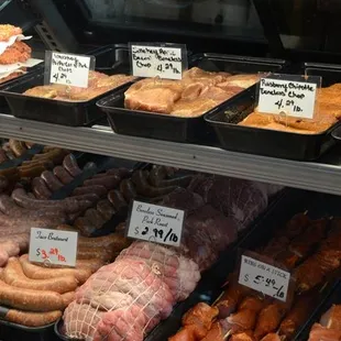 a variety of meats in a display case