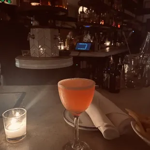 a glass of wine and a candle