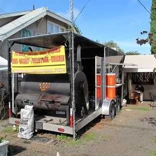 a bbq truck parked in front of a house