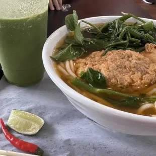 Canh Bun: simple broth with deep flavor, soft thick noodles, seafood patty with ong choi greens.