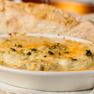 Warm Artichoke Gratin Artichoke hearts, béchamel, mixed cheese (Gruyère, Manchego, mozzarella) + batard toast