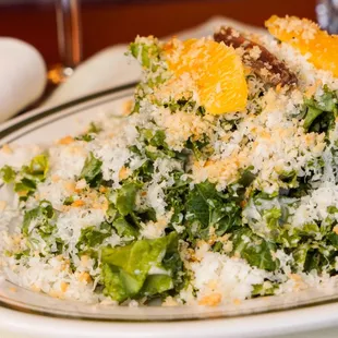 Kale Salad l'Obligatoire Organic kale with yogurt Caesar dressing, sliced orange, anchovies, Parmesan + seasoned bread crumbs.
