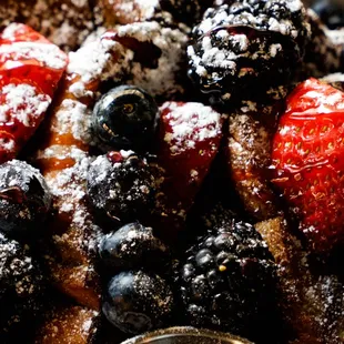 Pain Perdu French toast w/fresh berries, raspberry coulis, maple syrup + cream cheese icing