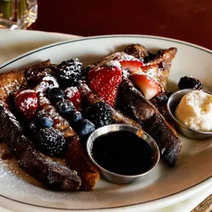 Pain Perdu French toast w/fresh berries, raspberry coulis, maple syrup + cream cheese icing