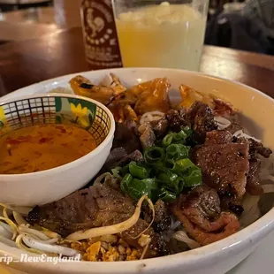 a bowl of noodles with meat and vegetables