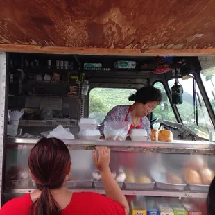 a woman serving food to a group of people