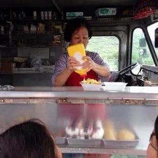 a woman serving food to a group of people