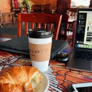 a croissant and a cup of coffee