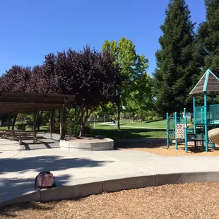 Picnic tables (semi-covered) and the small play structure.