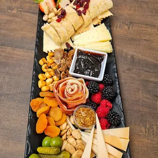 Goldilocks Cheese Board: triple cream brie, swiss, and gouda with various accouterments.
