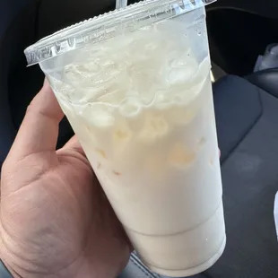 a hand holding a plastic cup