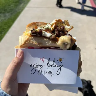 a person holding a piece of bread