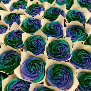 Multicolor piped frosting rosettes on cupcakes.