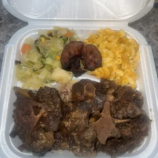 Oxtail, rice and peas, cabbage, plantains and mac