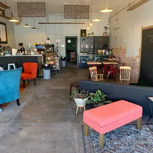 a woman sitting on a couch in a coffee shop