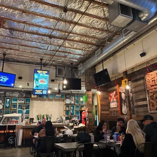 people sitting at tables in a restaurant